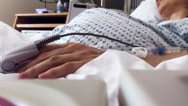 Sleeping Pregnant Woman on Hospital Bed