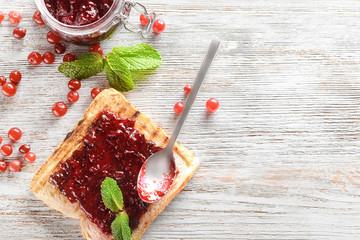 Delicious toast with sweet jam on wooden table