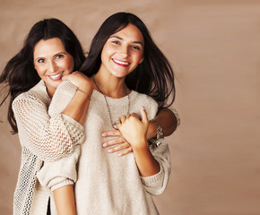 cute pretty teen daughter with mature mothr hugging, fashion style brunette