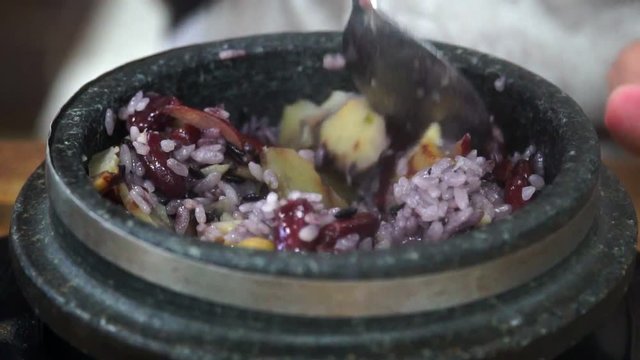 Eating Traditional Korean Dish Yeongyang Dolsotbap. Asian Authentic Cuisine