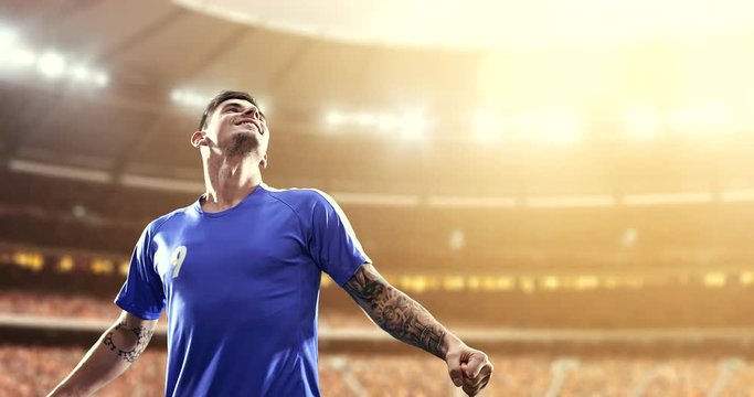 Happy soccer player on a football stadium