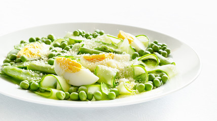 peas and pea pods, asparagus,  cucumber fresh crunchy salad with added boiled egg and grated cheese dressed with vinegar and oil 