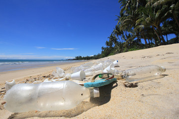 Plastic pollution on beach. Plastic bottles, bags and other garbage washes up in beach