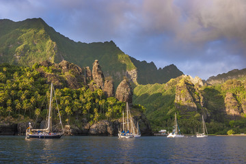 Sailing yachts anchoring in the Bay of Vergins, Marquesas Islands, French Polynesia
