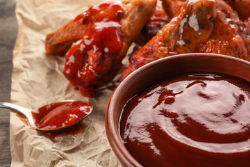 Delicious barbecue sauce in bowl on table