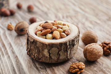 Mix of nuts on wooden background