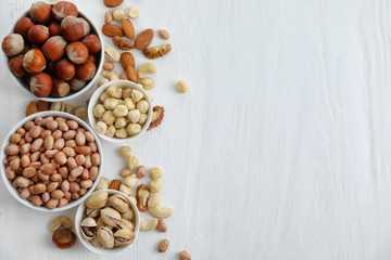 Fototapeta na wymiar Flat lay composition with different kinds of nuts on light background