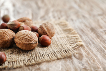 Tasty walnuts and hazelnuts on table