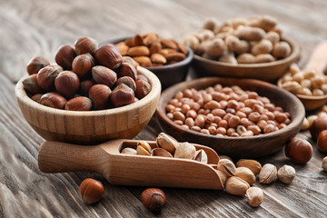 Composition with different kinds of nuts on wooden background