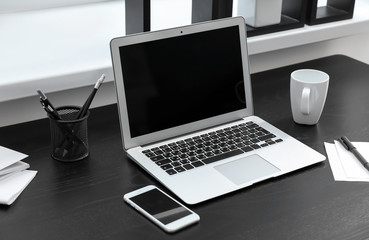 Stylish workplace with laptop on table