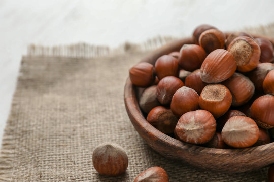 Plate With Tasty Hazelnuts On Table