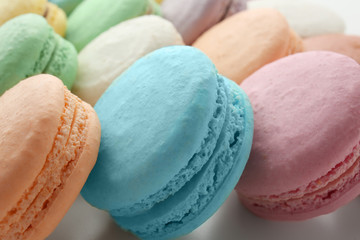 Tasty colorful macarons on white background, closeup