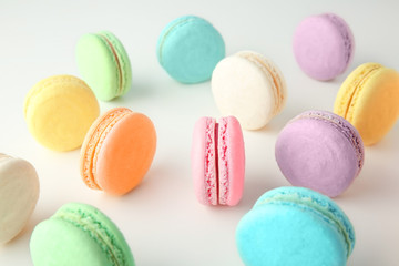 Tasty colorful macarons on white background