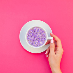 Cup of beautiful lilac flowers infused water