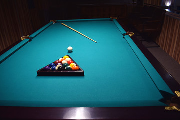 Colored balls of the American pool are collected in a triangle on a billiard table
