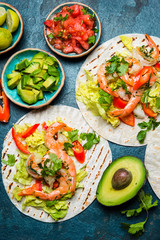 Shrimps tacos with salsa, vegetables and avocado. Mexican food
