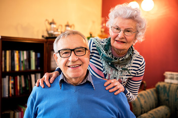 Portrait of smiling senior couple in love at home - Powered by Adobe