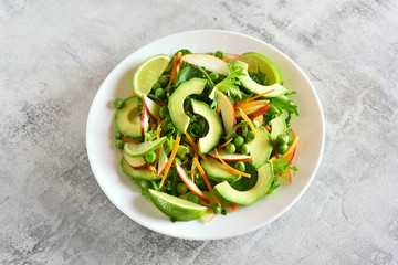 Fruit vegetable salad with avocado, green pea, greens, apple