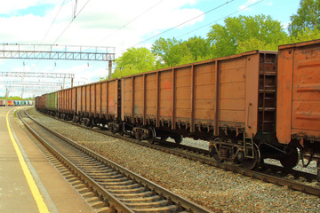Fototapeta na wymiar Freight railroad cars at the station. The train on the rails. Close-up.