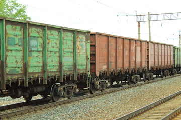 Freight railroad cars at the station. The train on the rails. Close-up.