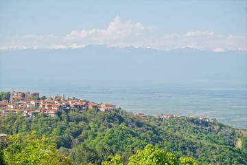 Landscape of Signagi town with Alazani Valley and Caucasus Mountains on the background, Kakheti, Georgia (Europe), Caucasus