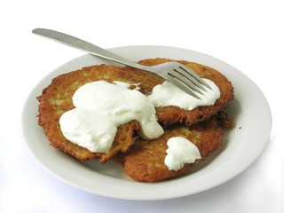 potato pancakes with cream as tasty vegetarian meal