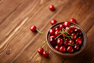 Fototapeta na wymiar Fresh red cherry on a dark wooden background. Cherries. Healthy food concept.
