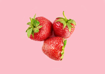 Fresh red strawberry isolated on a pink background. Summer berries. The concept of healthy eating.
