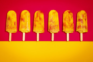 isolated delicious yellow-red ice cream on a colorful summer background