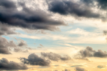 Abstract background, blue sky with dark cumulonimbus clouds.