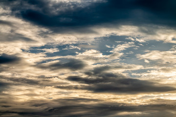 Abstract background, blue sky with dark cumulonimbus clouds.