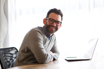 happy businessman smiling with laptop