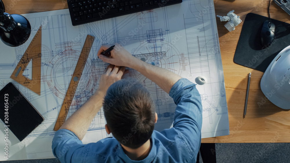 Poster top view of a technical engineer working on his blueprints, drawing on plans. various drawing object