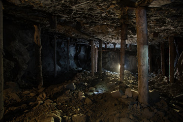 Fototapeta na wymiar Underground emerald ore mine shaft tunnel gallery with light