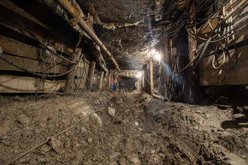 Fototapeta na wymiar Underground emerald ore mine shaft tunnel gallery with light scraper