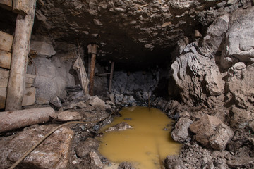 Underground emerald ore mine shaft tunnel gallery with water