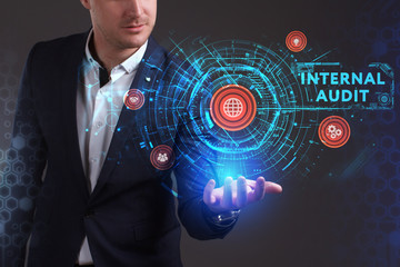 Business, Technology, Internet and network concept. Young businessman working on a virtual screen of the future and sees the inscription: Internal audit