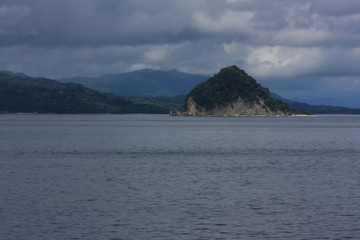 Coastal view of mountain range seen from a ferry ride from San Jose to La Playa Tambor, Costa Rica