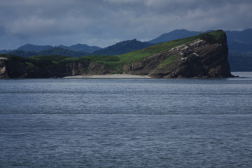Coastal view of mountain range seen from a ferry ride from San Jose to La Playa Tambor, Costa Rica