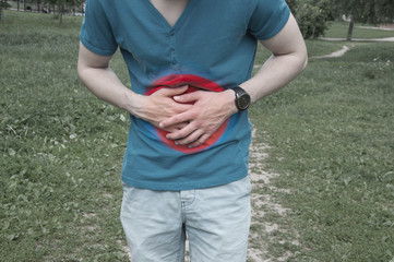 Man touching stomach. Stomach pain