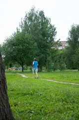 Man is training in the summer park. Sportsman running