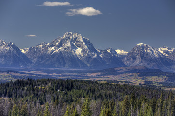 Grand Tetons in distance with forest and valley; Wyoming
