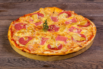 Pizza with ham and sausages