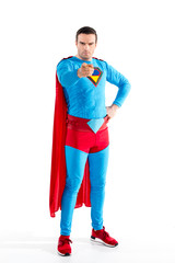 full length view of confident male superhero standing with hand on waist and pointing at camera...
