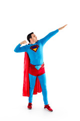 full length view of handsome man in superhero costume looking away isolated on white
