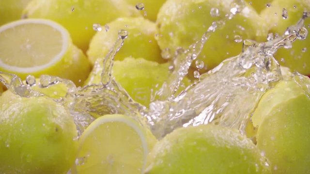 Lemon falling in water with splash between lemons. Slow motion 240 fps. Sony rx10 4