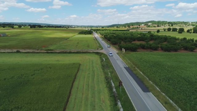 Car drive through the green field in Italy Drone flight 4k