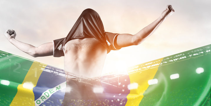 Brazil national team. Double exposure photo of stadium and soccer or football player celebrating goal with his jersey on head