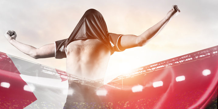 Denmark national team. Double exposure photo of stadium and soccer or football player celebrating goal with his jersey on head