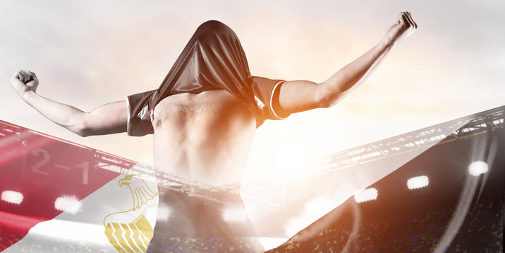 Egypt national team. Double exposure photo of stadium and soccer or football player celebrating goal with his jersey on head